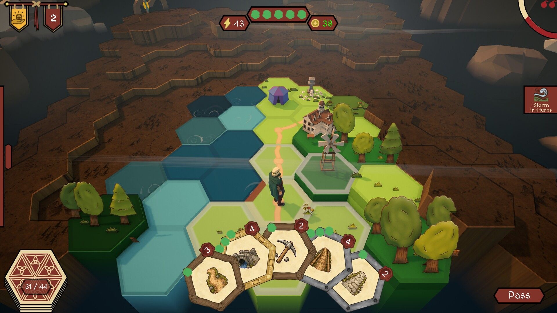 A road winds across grass and water hexes toward a windmill landmark, with bridge and pickaxe cards in hand.